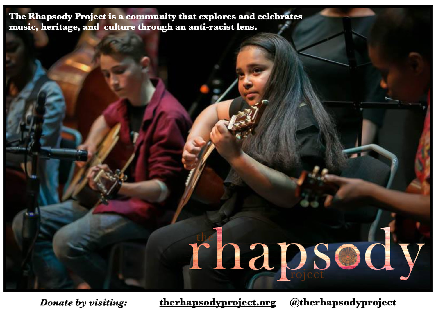 Rhapsody Project students seated together playing stringed instruments